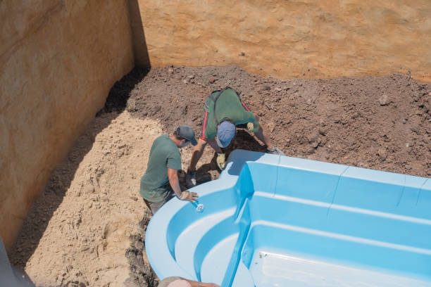 workers installing inground pool